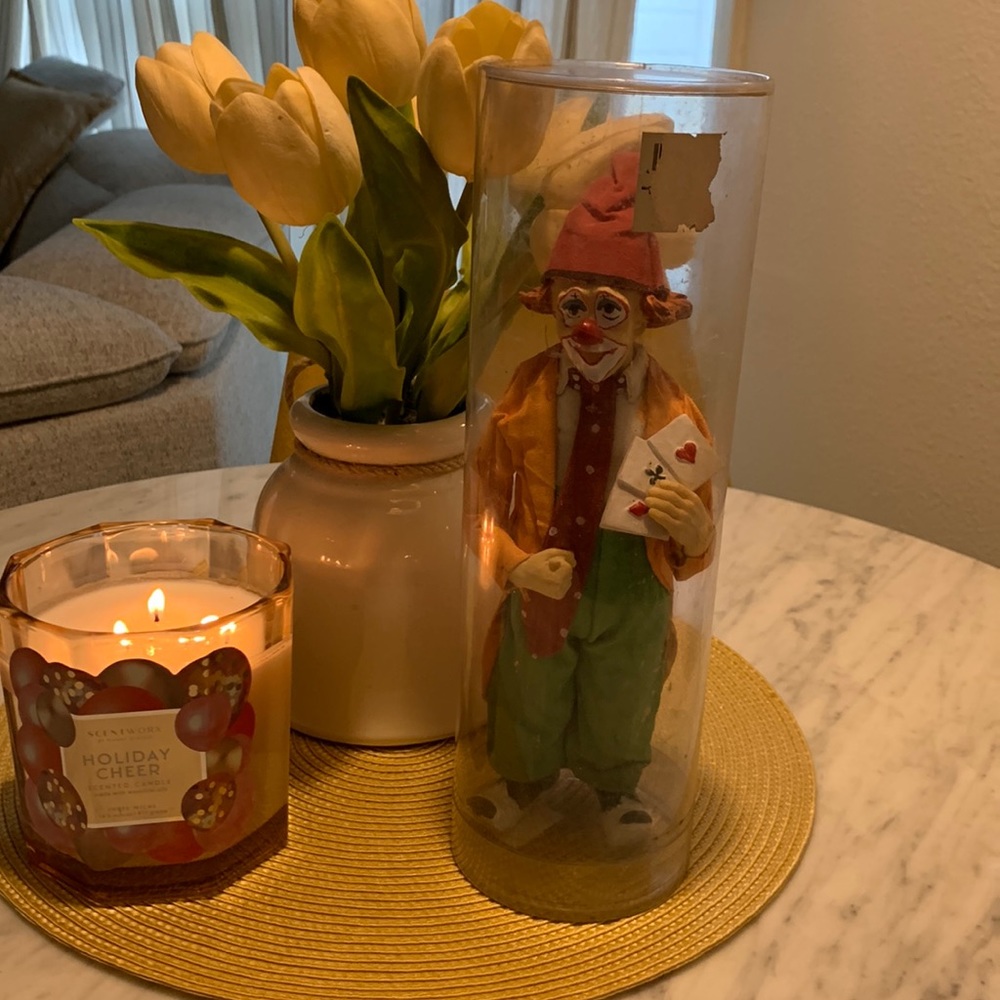 Vintage clown figurine doing magic with a deck of cards